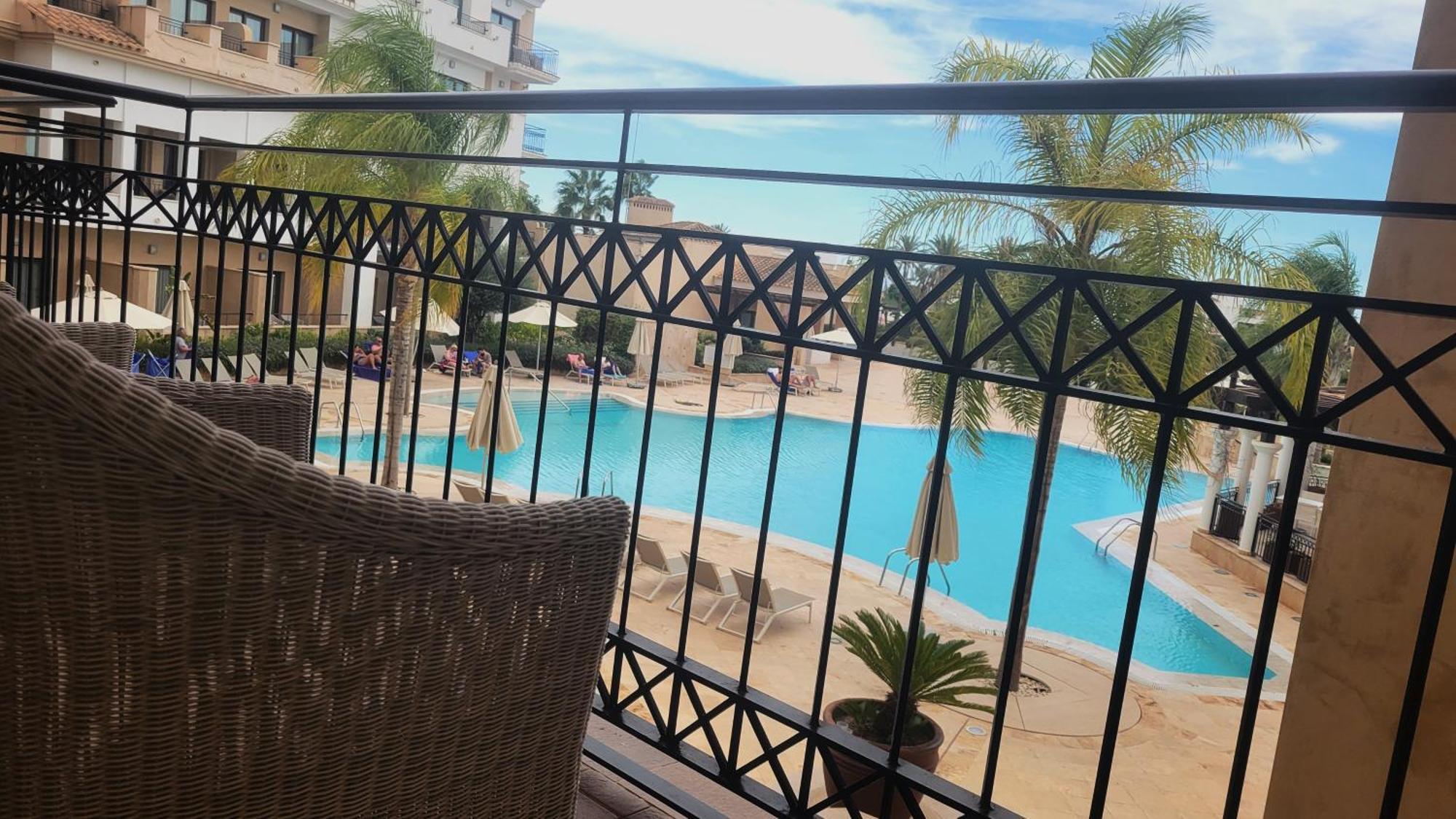 Doubletree By Hilton La Torre Golf Resort Roldan Bagian luar foto View of the pool at the hotel